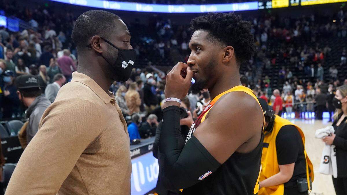 Utah Jazz minority owner Dwyane Wade, left, speaks with all-star Jazz guard Donovan Mitchell following a game on October 20, 2021. The Heat’s interest in a trade for Mitchell would involve both Wade and Jazz CEO Danny Ainge, Pat Riley’s longtime bitter rival.