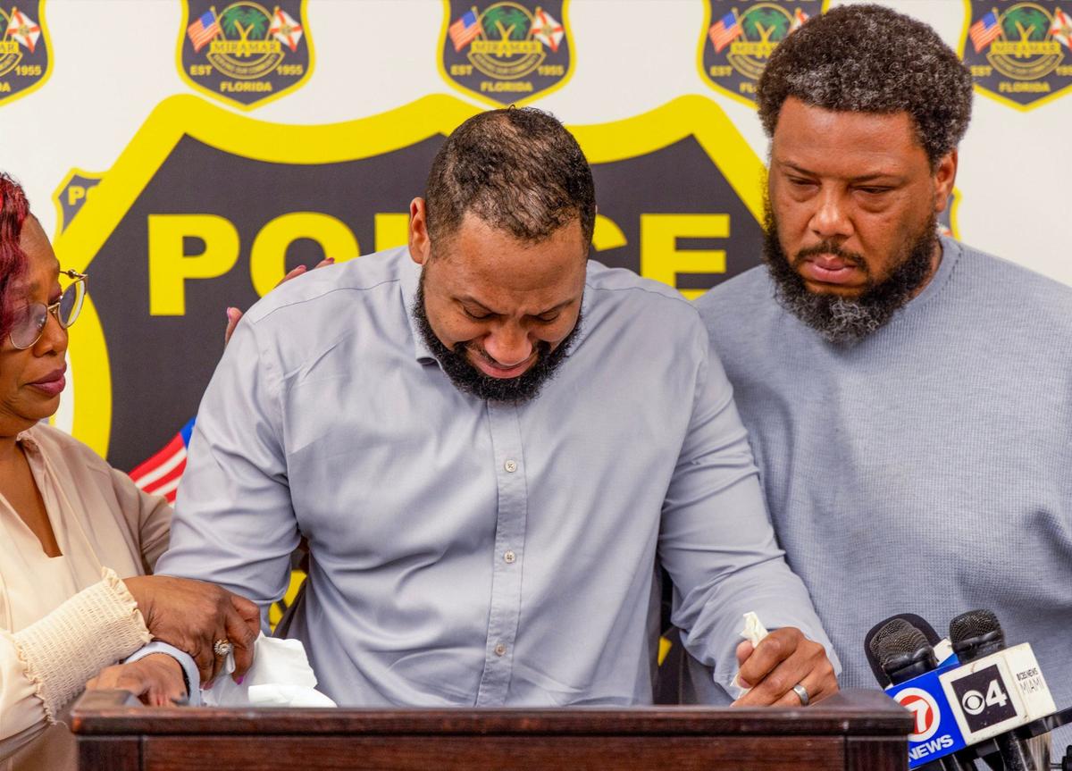 Flanked by family members, Roosevelt Delanois, center, the husband of Onyxia Delinois, 26, and the Miramar Police Department ask the public to help identify the driver who struck her on the 18300 block of Miramar Parkway before fleeing around 7 a.m. on Saturday, April 6, 2024. Delinois remained in critical condition at Memorial Regional Hospital in Hollywood on Wednesday, April 10, 2024.