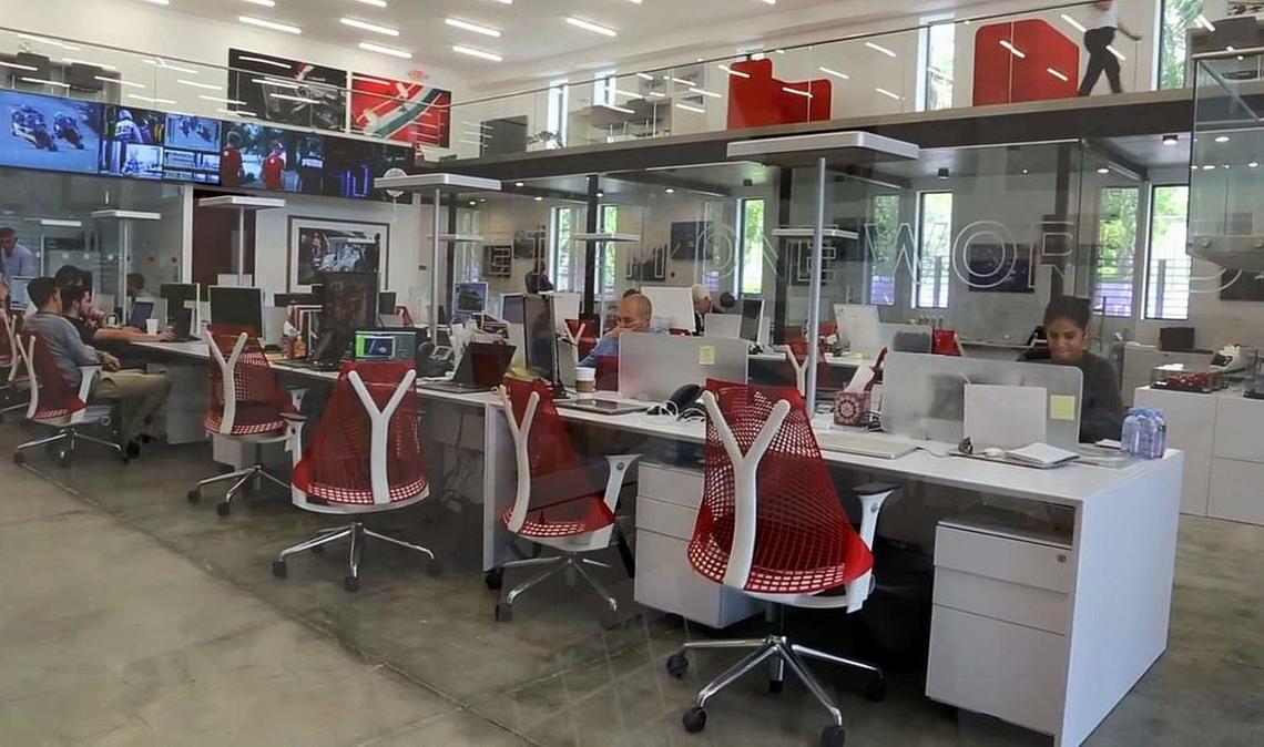 Office workers inside the Motorsports Network headquarters at 5972 NE Fourth Avenue in Little Haiti on Sept. 11, 2018.