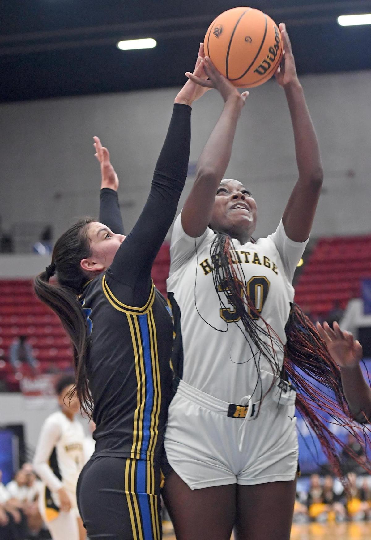 American Heritage’s Dezuray McGill (30) is fouled by Mainland’s Olivia Olsen (5) in the Class 5A final during the Florida High School State Championships at the RP Funding Center in Lakeland, Fl on Friday March 8, 2024. American Heritage defeated Mainland 60-55 to win the Class 5A State Title. Scott Wheeler | Photo