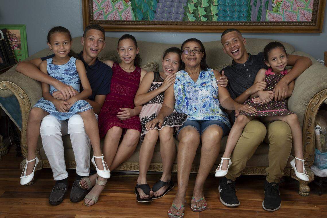 Miley, 8, Marcus, 15, Michelle, 13, Maria, 10, grandmother Peggy Guillou, Matthew, 16, and Marcia, 6, are siblings who were all born deaf. They are being raised by their grandmother. Over the past eight years, all of the children have been surgically fitted with bilateral cochlear implants allowing them to hear.