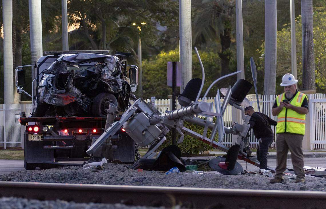 A vehicle involved in a collision with a Brightline train is seen on a towing truck as officials clear the area before it is removed near the 14100 block of Biscayne Boulevard in North Miami on Wednesday, Nov. 19, 2025. One person was airlifted to a trauma center.