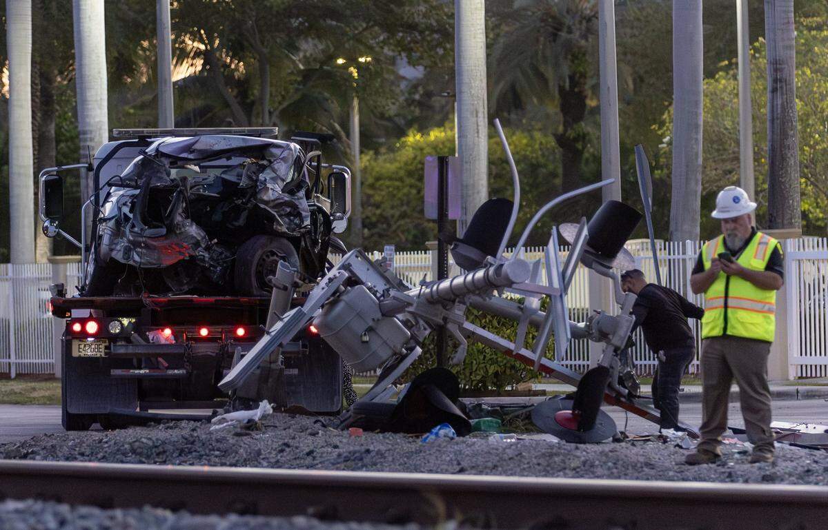 A vehicle involved in a collision with a Brightline train is seen on a towing truck as officials clear the area before it is removed near the 14100 block of Biscayne Boulevard in North Miami on Wednesday, Nov. 19, 2025. One person was airlifted to a trauma center.