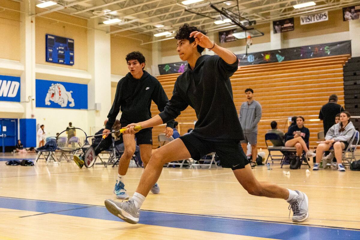 Cristian Toruno, 17, left, and Darren ku, 16, right, compete during the GMAC badminton tournament final for men’s doubles at Braddock High School in Miami, Florida, on Thursday, April 18, 2024.