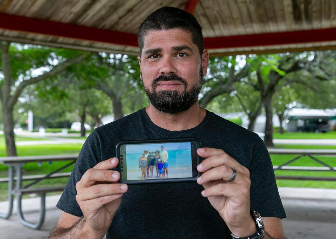 Pablo Rodriguez, 40, whose mother and grandmother died in the Champlain Towers South collapse in Surfside, Florida holds a family portrait on Tuesday, July 13, 2021.
