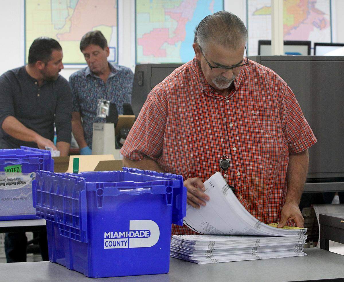 Miami-Dade County Election department staff members work on the recount process at the elections department in Doral on Saturday November 10, 2018