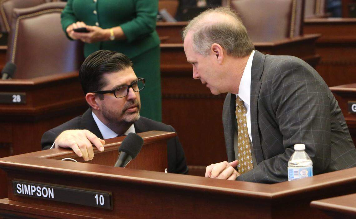 Florida Sen. Manny Diaz, Jr., R- Hialeah, left, talks with Sen. Wilton Simpson, R-Trilby, on the floor of the Florida Senate on April 30, 2019.