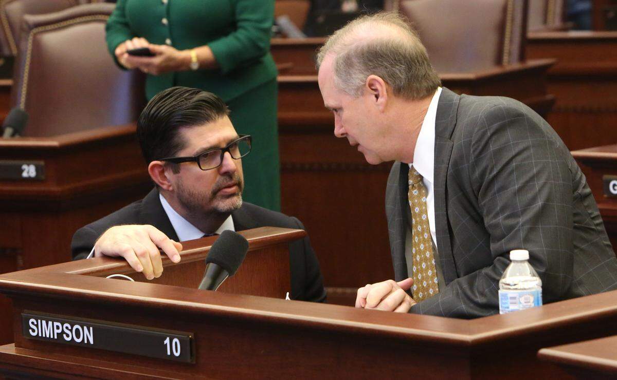 Florida Sen. Manny Diaz, Jr., R- Hialeah, at left, talks with Sen. Wilton Simpson, R- Trilby, on the floor of the Florida Senate, Tuesday, April 30, 2019.