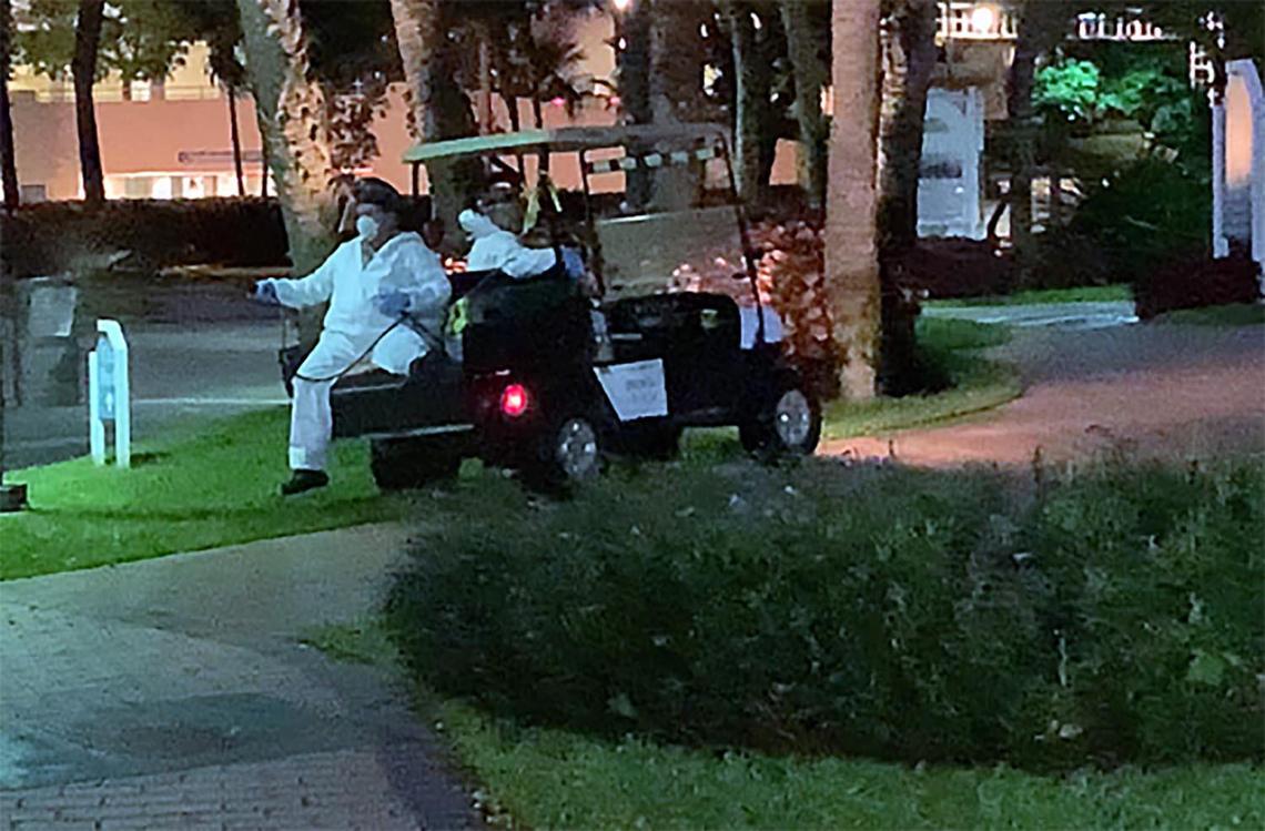 Employees at Brickell Key apply disinfectant spray around the island to prevent the spread of coronavirus.