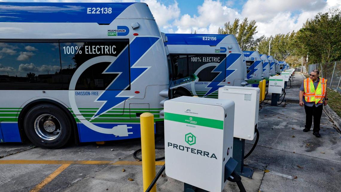 Lazaro Dominguez, with the Department of Transportation and Public Works, walks past a row of broken electric Proterra buses parked at Miami-Dade County Coral Way Bus Maintenance Facility in Miami on Wednesday, February 19, 2025. The majority of Miami-Dade’s electric buses haven’t been serviced since the bus company, Proterra, filed for bankruptcy.