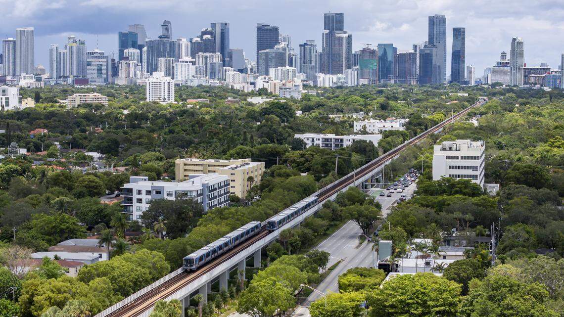 Metrorail trains make their way through Coconut Grove and the Silver Bluff neighborhood on Thursday, Aug. 7, 2025, in Miami. City of Miami officials recently approved the Transit Station Neighborhood Development program, which will allow for increased development within a mile of rail stations. An exemption for Coconut Grove was written into the initiative.