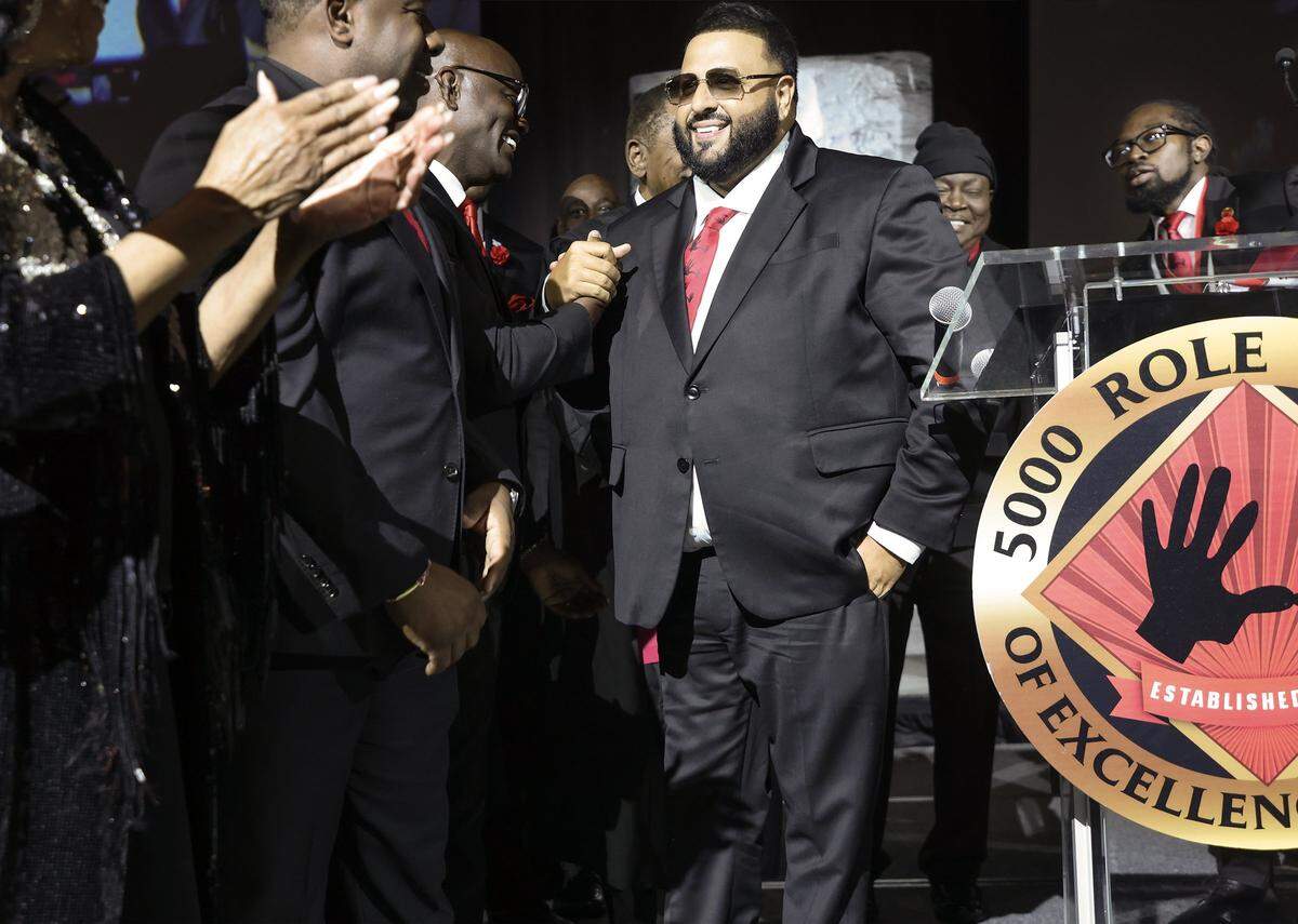 2026 Headliner Khaled “DJ Khaled”  Mohammed Khaled, center, is congratulated after giving his remarks. The 5000 Role Models held its 33rd Annual Dr. Martin Luther King, Jr. Annual Scholarship Breakfast with Keynote Speaker Bishop Neil C. Ellis, and the 2026 Headliners consisting of Lee “Freezy Prince” Prince, Tramar “Flo Rida” Lacel Dillard, Maurice “Trick Daddy” Samuel Young, and Khaled “ DJ Khaled” Mohammed Khaled, on Monday, January 19, 2026, at the Miami Beach Convention Center, in Miami Beach, Florida. 
