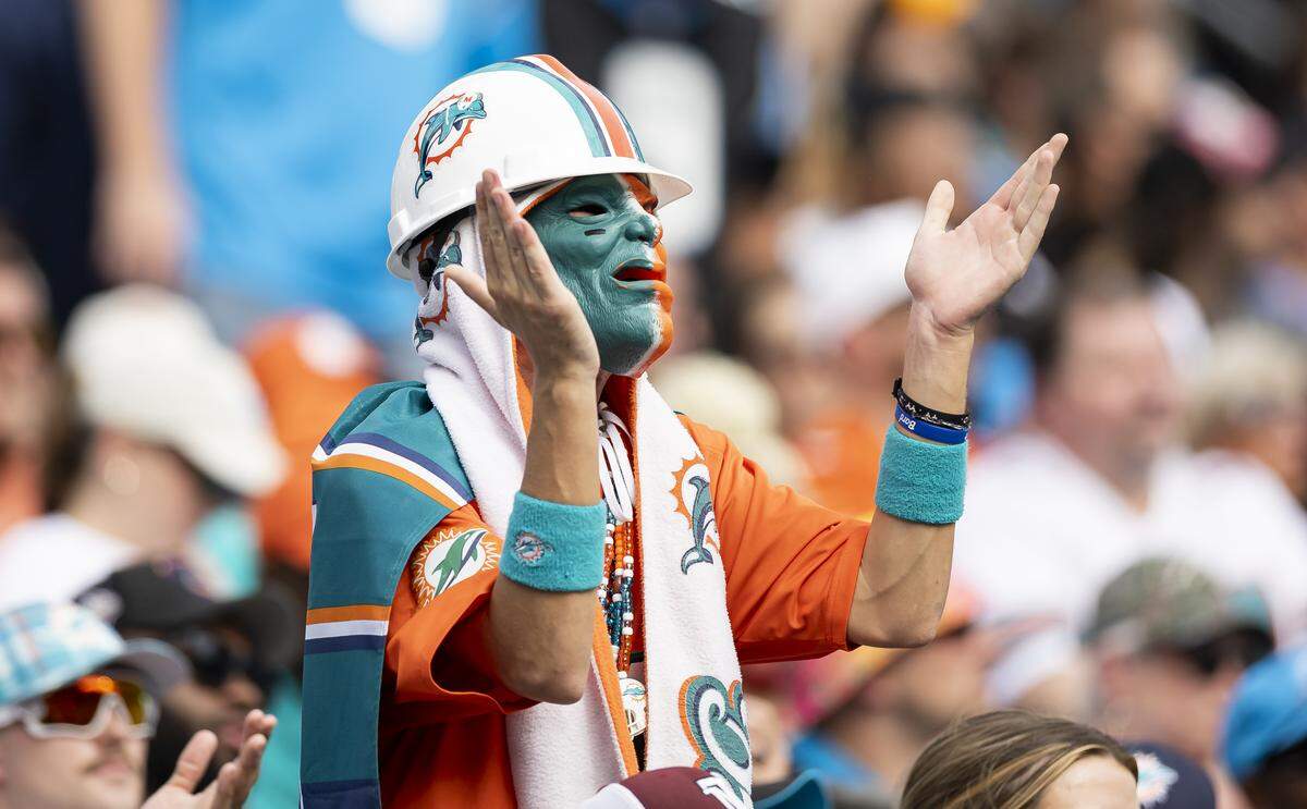 A Miami Dolphins fan cheers for his team as they play against the Carolina Panthers in the second half of their NFL game at the Bank of America Stadium on Sunday, Oct. 5, 2025, in Charlotte, N.C.