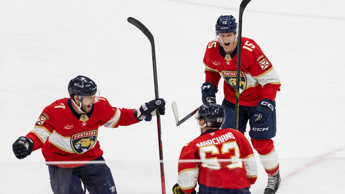 Florida Panthers center Brad Marchand (63) celebrates with center Anton Lundell (15) and defenseman Dmitry Kulikov (7) after scoring a goal against Toronto Maple Leafs goaltender Joseph Woll (60) in a Overtime period of Game 3 of a second-round Stanley Cup playoffs series at the Amerant Bank Arena on Friday, May 9, 2025, in Sunrise, Fla.
