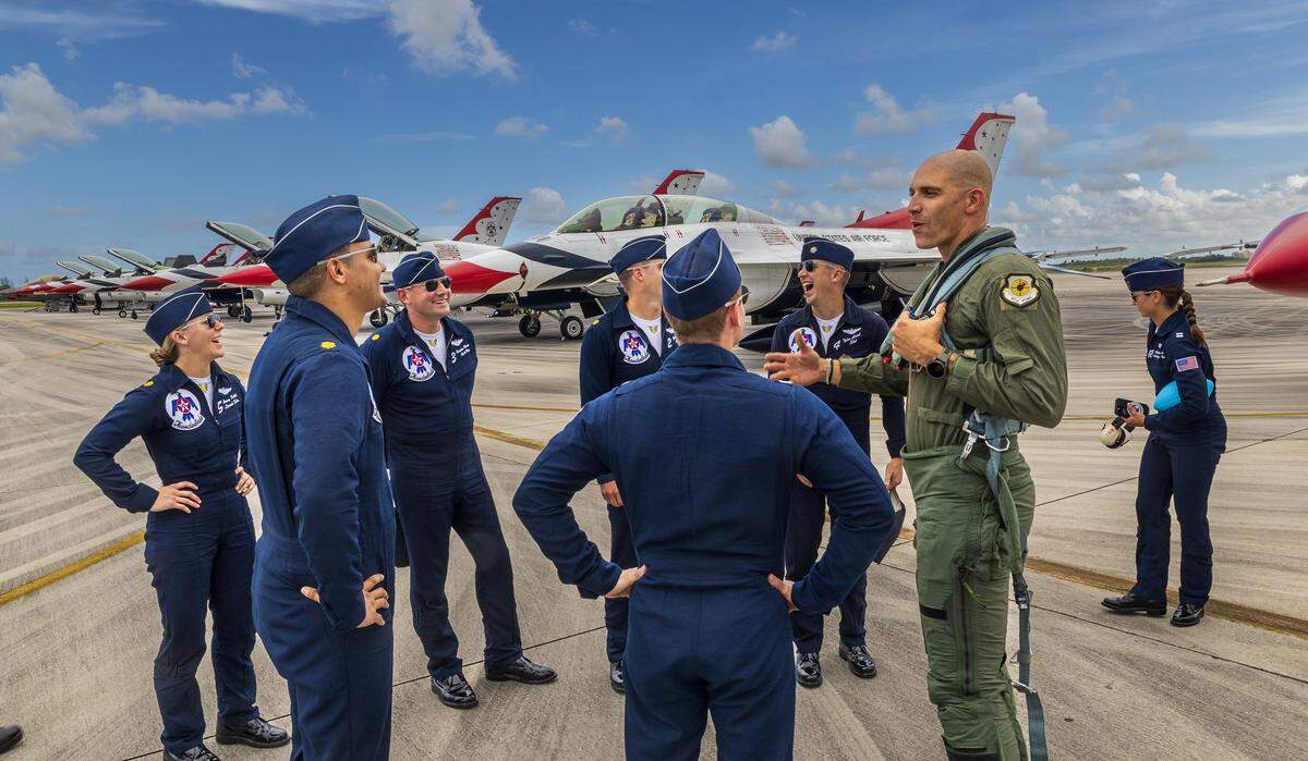 NFL star Jimmy Graham talks with demonstration pilots after their flight with him flying as a civilian passenger in the backseat of Maj. Samuel “RaZZ” Larson’s Thunderbird F-16 Fighting Falcon during a practice flight on Friday, May 22, 2026.