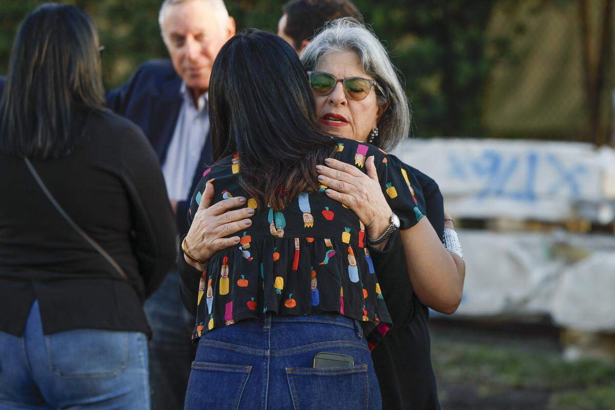 Miami-Dade Mayor Daniella Levine Cava embraces Raquel Oliveir, while attending a Moment of Reflection marking the transition into the next phase of the Champlain Towers South Memorial project at Veterans Park, in Surfside, Florida on Wednesday, February 4, 2026. Oliveira lost her son Lorenzo Olveira Leone, 5, and husband Alfredo Leone during the collapse.