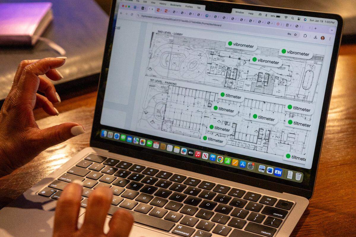 Lisa Gardner, president of the condominium association at the Marenas Beach Resort, shows how she monitors the innovative SmartCore sensor system set up around the building that detect motion on Jan.19.