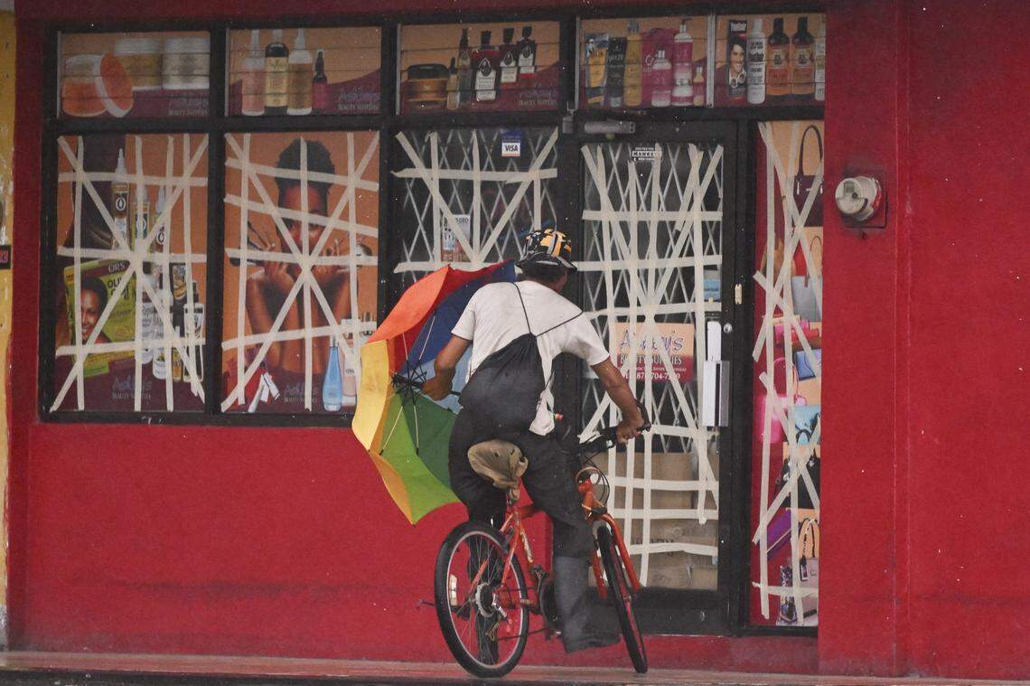 A cyclist rides up to a store to seek shelter from Hurricane Mellisa in Portmore on October 26, 2025. Hurricane Melissa was cutting a deadly path in the Caribbean on the night of October 25, with rapid intensification expected over the weekend as it took a worryingly slow course toward Jamaica and the island of Hispaniola, forecasters said. (Photo by Ricardo Makyn / AFP) (Photo by RICARDO MAKYN/AFP via Getty Images)          