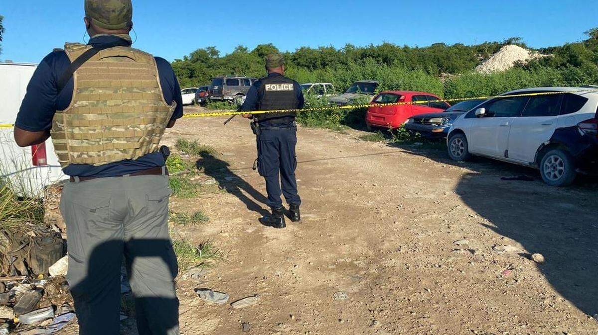 Royal Turks and Caicos Police Force officers go to the scene of a triple murder in Turks and Caicos Island on Nov. 1, 2022.