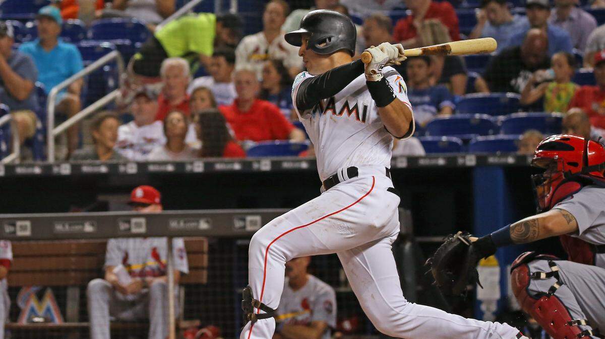 Miami Marlins third baseman Martin Prado hits a single during the first inning of a Major League Baseball game  against the St. Louis Cardinals at Marlins Park on Wednesday, August 8, 2018.