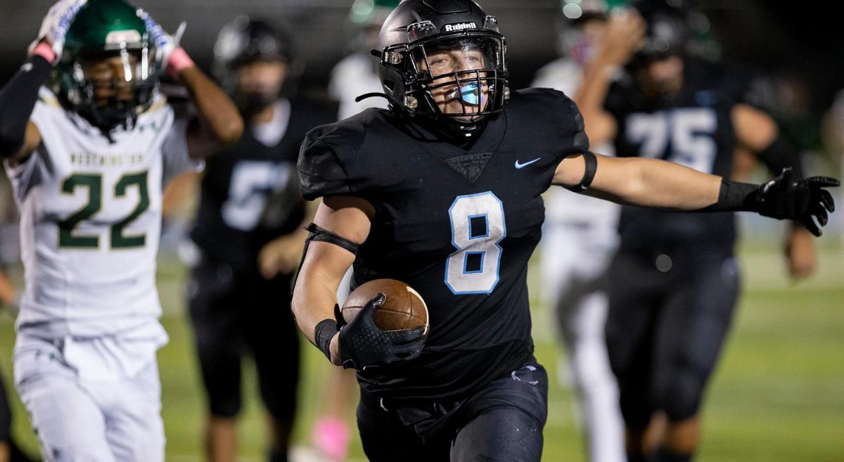 Archbishop Carroll Bulldogs fullback Sylus Villanueva (8) reacts after scoring a touchdown against the Westminster Christian Warriors during the third quarter of a high school football game at Tropical Park on Friday, Oct. 21, 2022, in Miami, Fla.