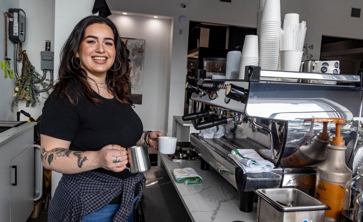 Joelle Maritza serves up coffee to clients at the White Rose Coffee Shop, which she co-owns with Javier Betancourt, who combined it with his Ocho Placas Tattoo shop.