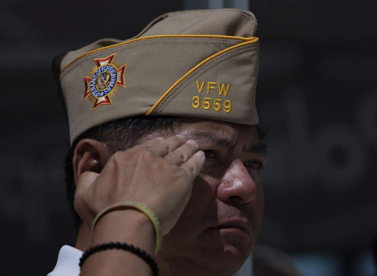  Lt. Col. Jackie Tam, Veterans of Foreign Wars 3559 commander, salutes during the 21 gun salute at a Memorial Day Commemoration on Monday, May 25, 2026, at Miami Beach Police Headquarters in Miami Beach, Fla. 