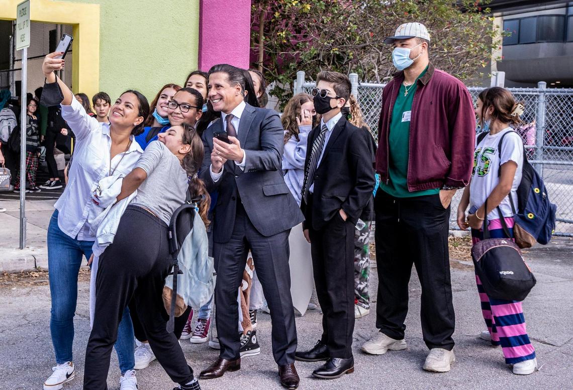  Miami-Dade Public Schools Superintendent Alberto Carvalho poses for a selfie with students from the iPrep Academy in Miami and Miami Dolphins player Brennan Scarlett at dismissal time on Friday, Dec. 17, 2021. Carvalho announced on Dec. 9 that he was leaving Miami to become the head of schools in Los Angeles.