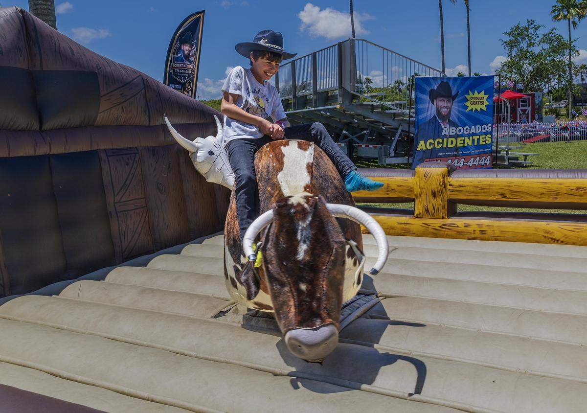 Anton Herrera rides a mechanical bull, during the Miami-Dade CountryFest 2026, at Tropical Park, an annual festival free of charge event that offers a weekend of entertainment for all ages, in Miami on Saturday, April 25, 2026.