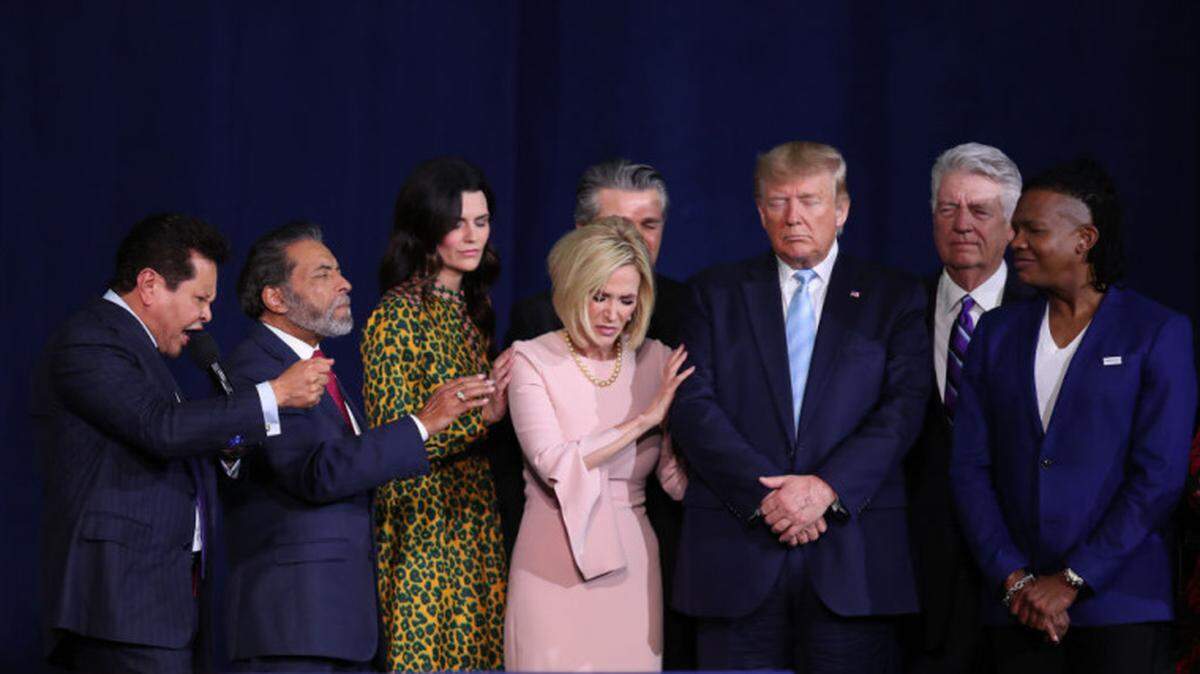 Faith leaders pray over President Trump during his Jan. 3 “Evangelicals for Trump” campaign event at the King Jesus International Ministry in Miami.