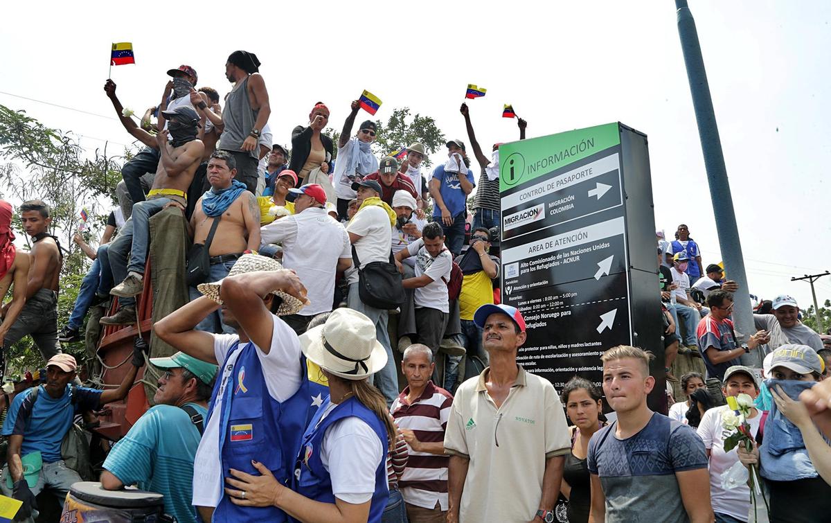 Hundreds seated on top of several trucks loaded with aid donated for Venezuelans at the Simon Bolivar International bridge on the Colombian side as interim President Juan Guaido Guaido and his supporters were hoping to move humanitarian aid into Venezuela Saturday against the wishes of leader Nicolas Maduro on February 23, 2019.