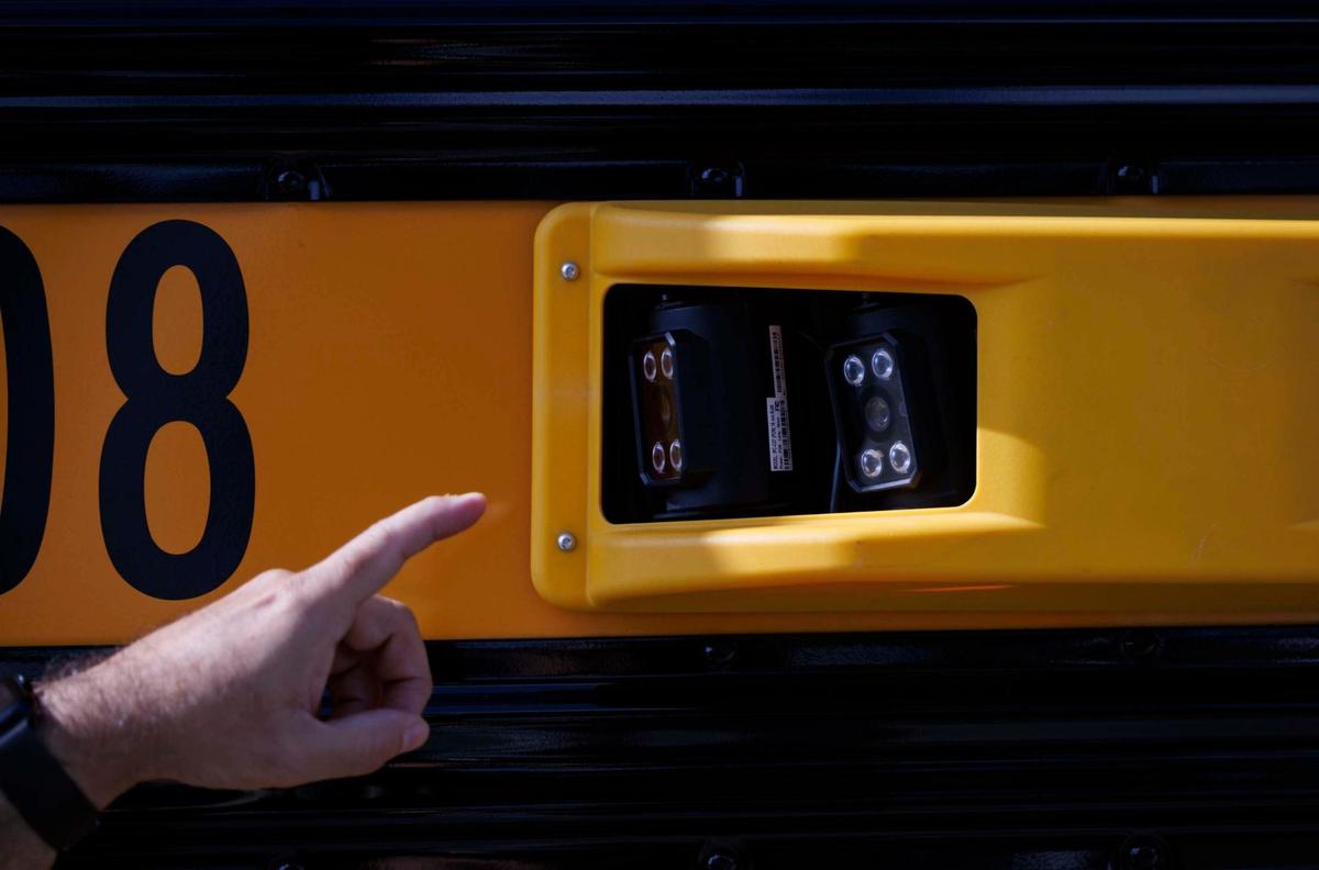 A Miami-Dade Public Schools official points to the new license plate reading cameras that are able to record up to eight lanes of traffic. The cameras are part of a new enforcement program to fine drivers who don’t stop for school buses. The program will start enforcing the fines on May 8.