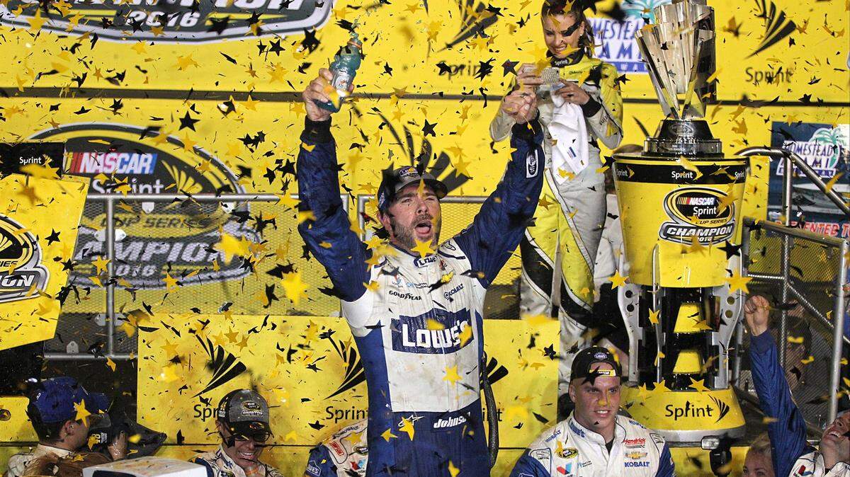 Jimmie Johnson, center, celebrated as confetti rains down after winning NASCAR Sprint Cup Championship and NASCAR Sprint Cup Series Ford EcoBoost 400 Championship at Homestead-Miami Speedway on Sunday, November 20, 2016.
