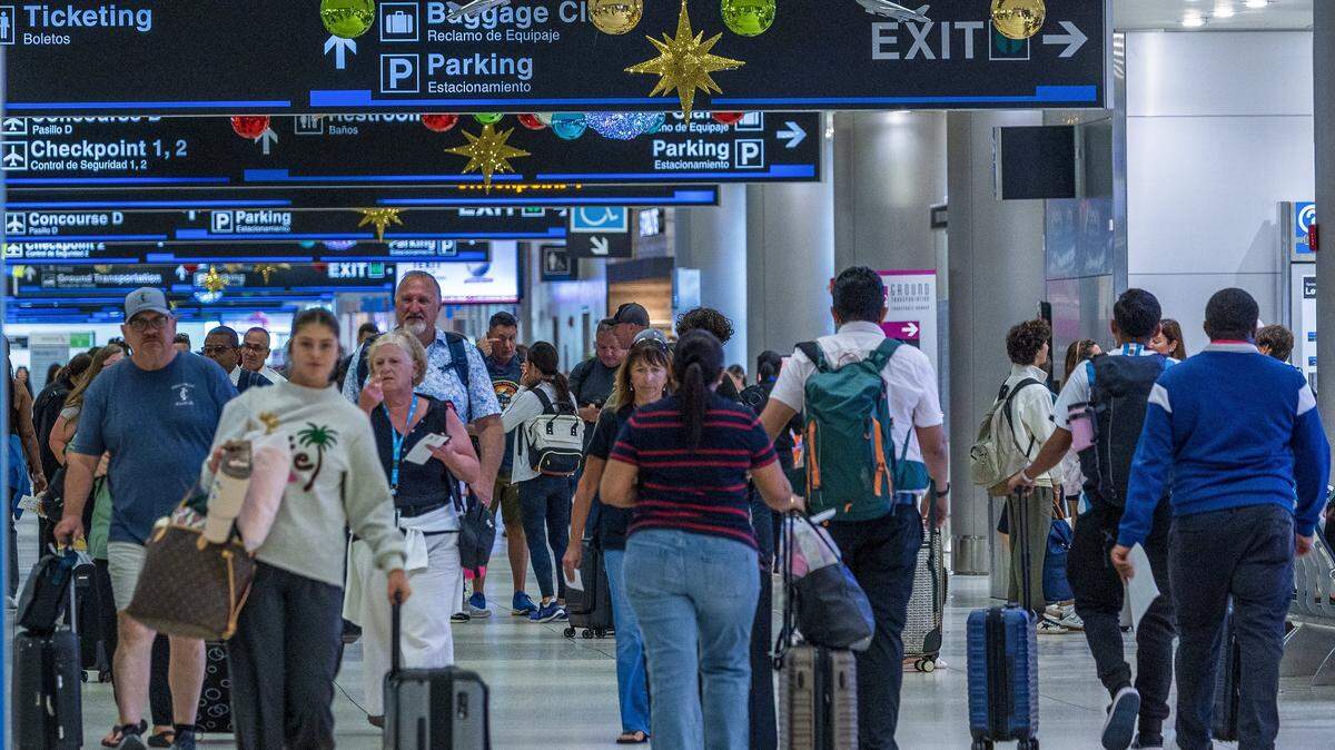 Passengers walked down the hallway in Concourse D, at Miami International Airport ahead of the holidays in Miami.