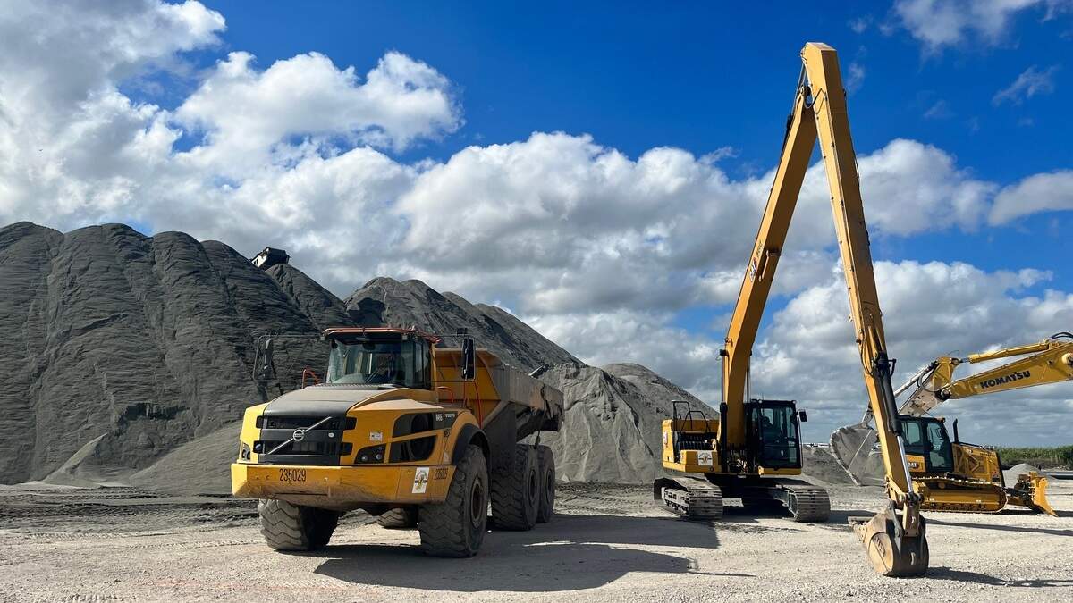 Heavy machinery is lined up in front of a massive pile of granite, as construction of the Everglades Agricultural Area Reservoir begins in February.