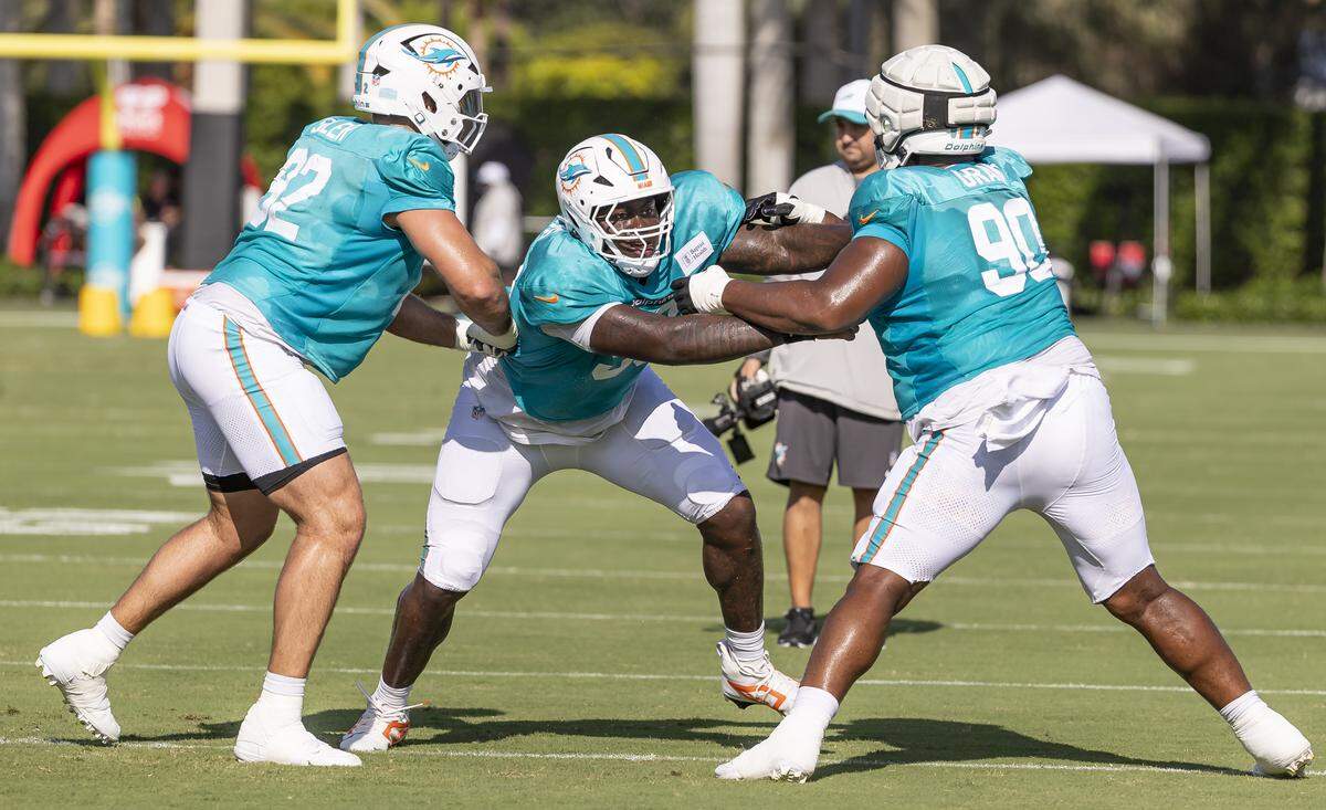Miami Dolphins defensive tackles Zach Sieler (92), Zeek Biggers (93) and Kenneth Grant (90) run drills during training camp at the Baptist Health Training Complex on Tuesday, July 29, 2025, in Miami Gardens, Fla.