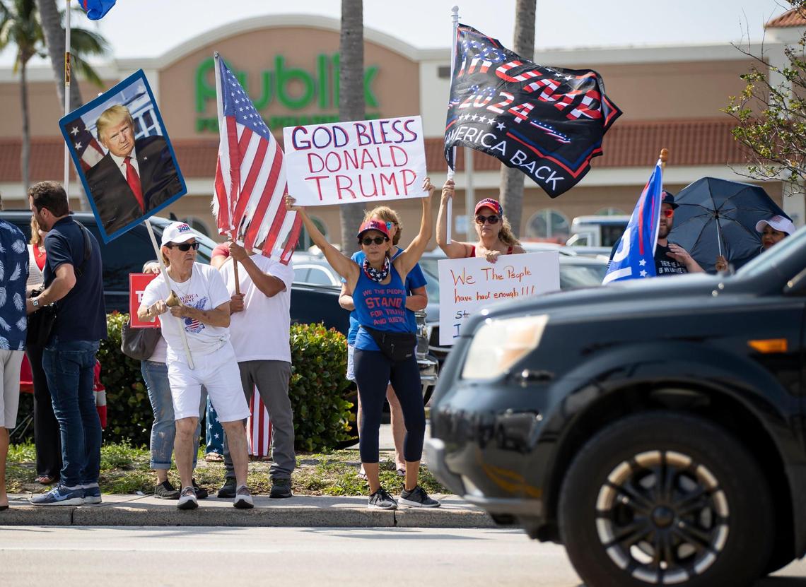 Former President Donald Trump’s supporters wave signs and flags during a rally on Monday, April 3, 2023, in West Palm Beach, Florida. The supporters gathered to see Trump’s motorcade as it headed to Palm Beach International Airport.
