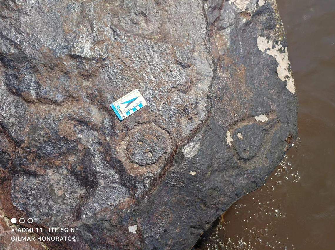 A circular face carving and another tear-drop shaped engraving.