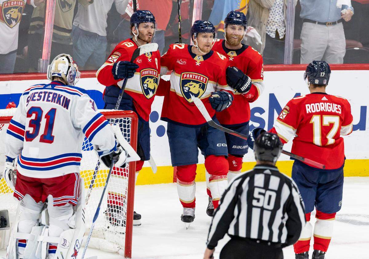 Florida Panthers defenseman Gustav Forsling (42) celebrates with center Sam Bennett (9), Matthew Tkachuk (19) and Evan Rodrigues (17) after scoring a goal against New York Rangers goaltender Igor Shesterkin (31) in the third period of Game 3 during the Eastern Conference finals of the NHL hockey Stanley Cup playoffs at the Amerant Bank Arena on Sunday, May 26, 2024, in Sunrise, Fla.