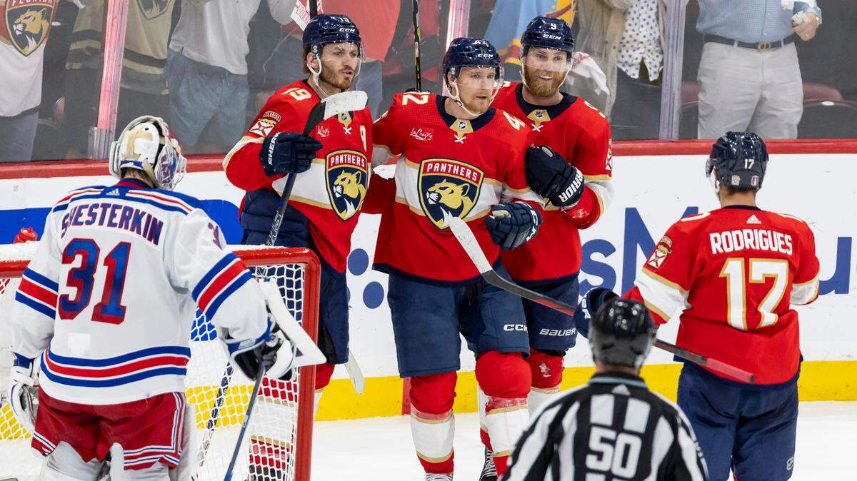 Florida Panthers defenseman Gustav Forsling (42) celebrates with center Sam Bennett (9), Matthew Tkachuk (19) and Evan Rodrigues (17) after scoring a goal against New York Rangers goaltender Igor Shesterkin (31) in the third period of Game 3 during the Eastern Conference finals of the NHL hockey Stanley Cup playoffs at the Amerant Bank Arena on Sunday, May 26, 2024, in Sunrise, Fla.