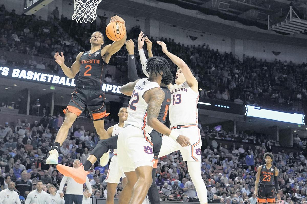 Miami guard Isaiah Wong shoots against Auburn defenders during the first half of a Round 2 NCAA Tournament game on Sunday night in Greenville, S.C. Wong led the Hurricanes with 21 points and he grabbed six rebounds.