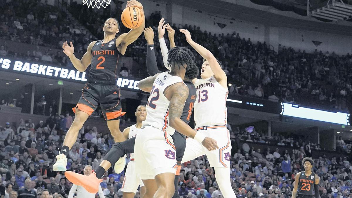 Miami guard Isaiah Wong shoots against Auburn defenders during the first half of a Round 2 NCAA Tournament game on Sunday night in Greenville, S.C. Wong led the Hurricanes with 21 points and he grabbed six rebounds.