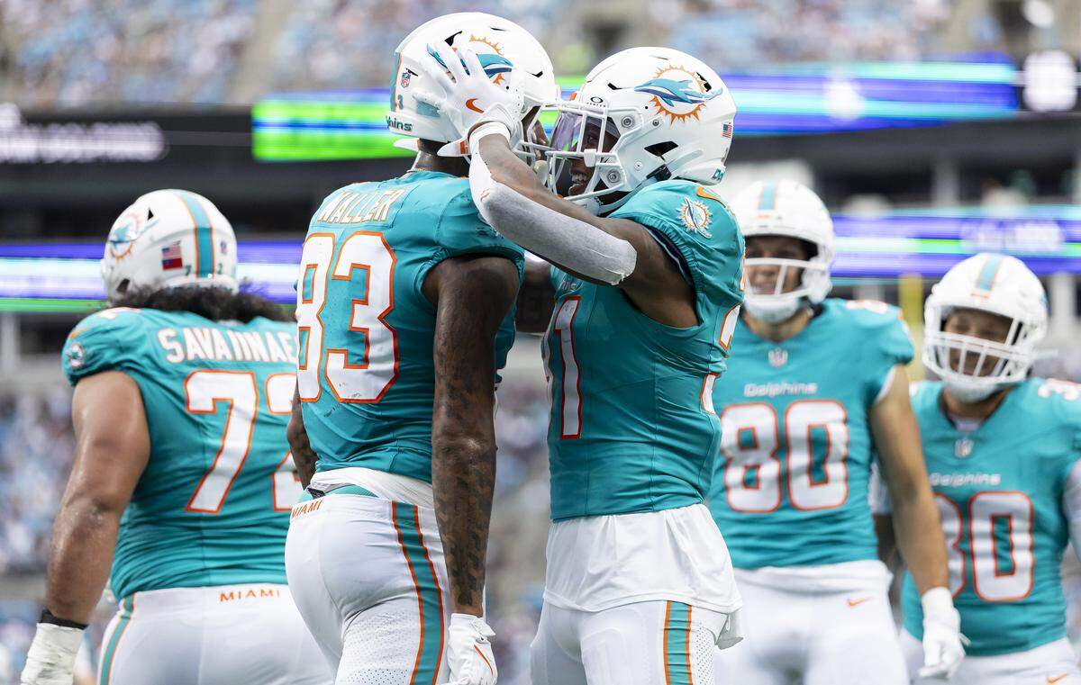 Miami Dolphins tight end Darren Waller (83) celebrates with running back Ollie Gordon II (31) after scoring a touchdown against the Carolina Panthers in the first half of their NFL game at the Bank of America Stadium on Sunday, Oct. 5, 2025, in Charlotte, N.C.