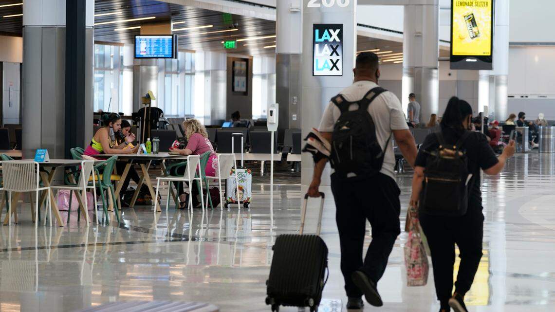 Passengers wait for their flights inside the new West Gates at Tom Bradley International Terminal at Los Angeles International Airport Monday, May 24, 2021, in Los Angeles. Airfare prices are rising amid Russia’s invasion of Ukraine, but experts say higher prices won’t stop travelers.