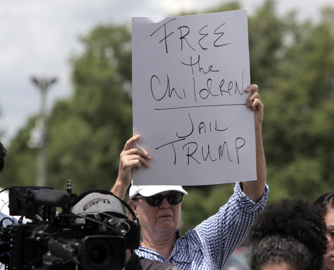 A protester holds up a sign during a press conference in front of the detention center in Homestead. U.S. Sen. Bill Nelson and U.S. Rep. Debbie Wasserman Schultz were denied entry to the Homestead Temporary Shelter for Unaccompanied Children.