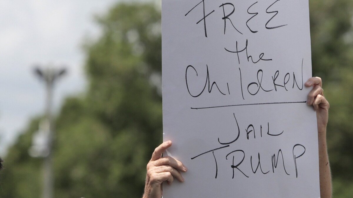 A protester holds up a sign during a press conference in front of the detention center in Homestead. U.S. Sen. Bill Nelson and U.S. Rep. Debbie Wasserman Schultz were denied entry to the Homestead Temporary Shelter for Unaccompanied Children.