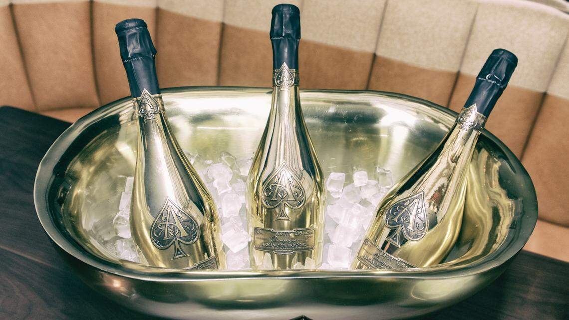 Three NYPD police officers are accused of stealing concertgoers’ champagne bottles at electronic music festival in NYC, officials say.