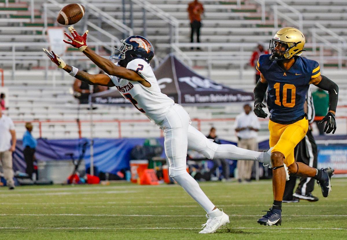 Homestead Broncos Cortez Mills (2) dives for a first down pass reception as St. Thomas Aquinas Bryant Allen (10) defends in the second half of the Class 3M state championships at Bragg Memorial Stadium in Tallahassee, Florida on Saturday, December 9, 2023.