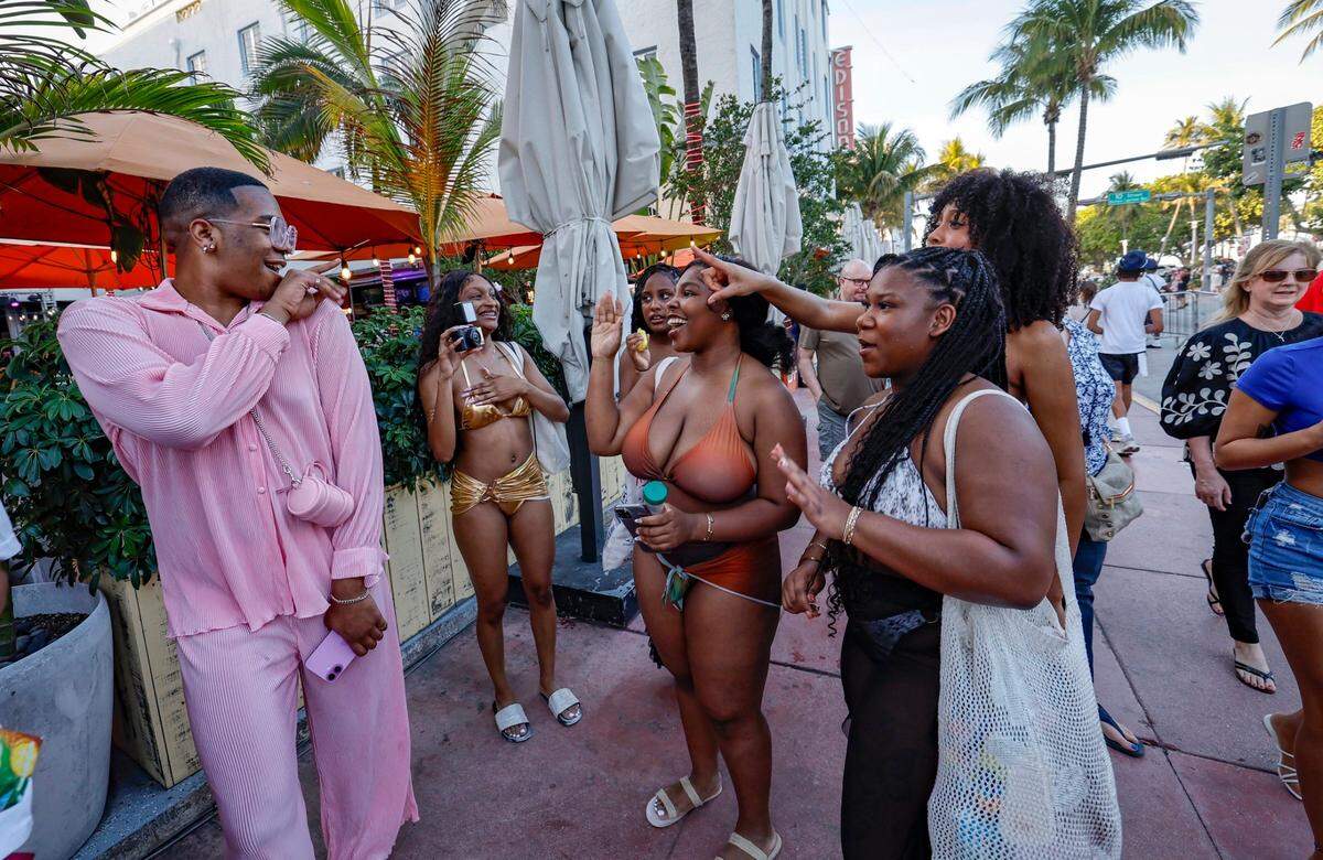 Otharin Liggins, 21, from Atlanta, blows a kiss and waves to the women walking along along Ocean Drive during spring break, Miami Beach, Florida on Friday, March 14, 2025.