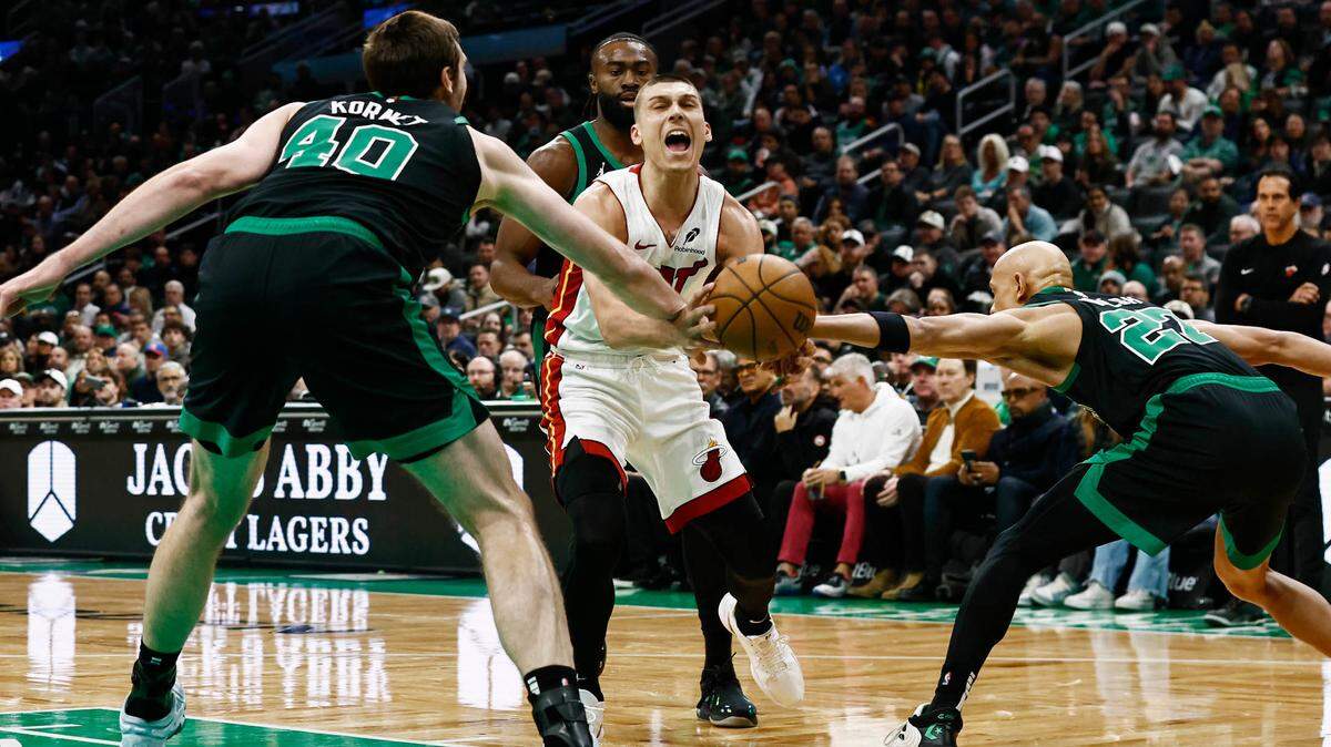 Miami Heat guard Tyler Herro (14) has the ball knocked away from him by Boston Celtics center Luke Kornet (40) and guard Jordan Walsh (27) during the first quarter at TD Garden.